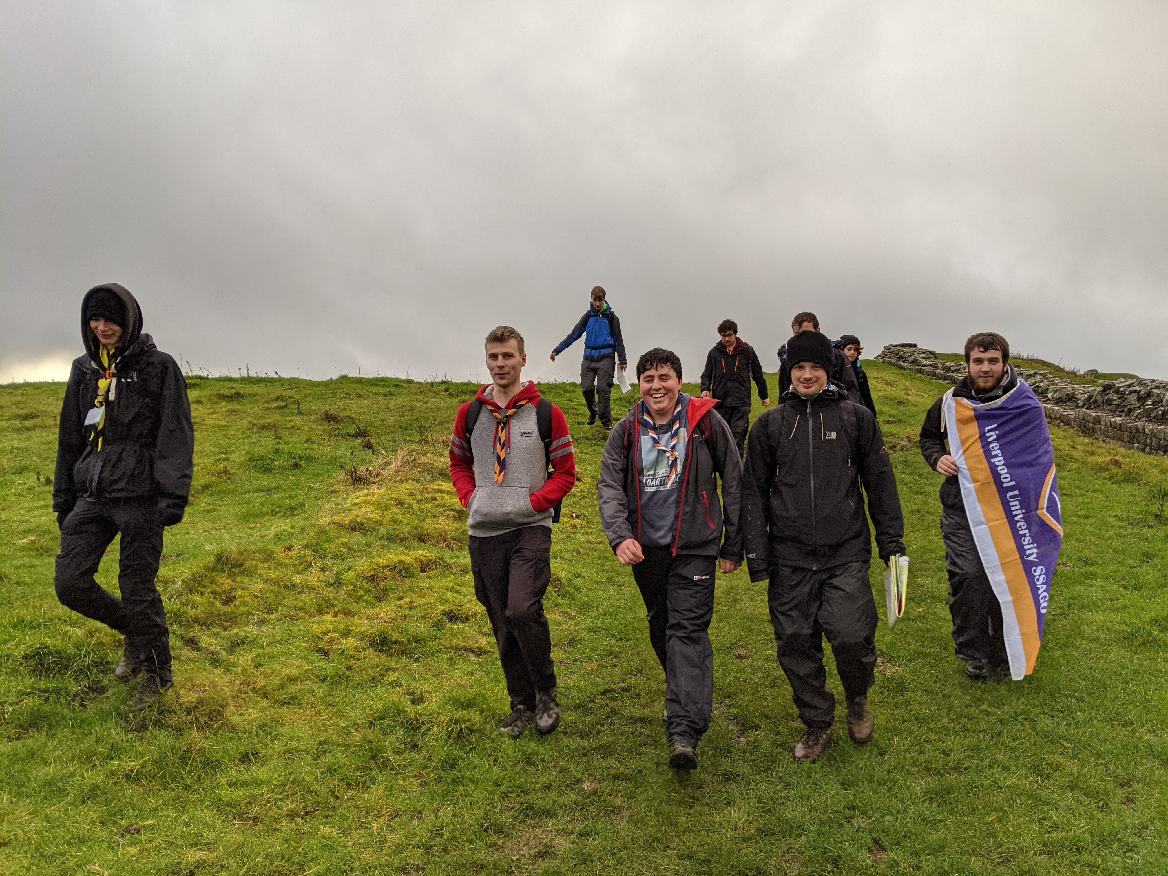 Group photo of those on the Hard Hike activity, walking alongside Hadrian's Wall